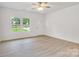 Bright living room featuring hardwood floors, large windows, and ceiling fan at 5185 Grand Canyon Rd, Concord, NC 28027