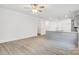 Bright living area that flows into the kitchen, featuring hardwood floors and modern lighting at 5185 Grand Canyon Rd, Concord, NC 28027