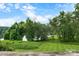Sprawling lawn with lush trees and landscape with peaceful lake views in the distance at 5192 Corbin Ln, Hickory, NC 28601