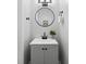 Clean bathroom featuring a gray vanity, round mirror, and modern matte-black fixtures at 5192 Corbin Ln, Hickory, NC 28601