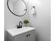 Well-lit bathroom with modern vanity, round mirror, and sleek black faucet fixtures at 5192 Corbin Ln, Hickory, NC 28601