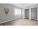 Bright bedroom with closet, window with sheer curtains and wood-look flooring at 5192 Corbin Ln, Hickory, NC 28601