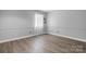 Bright bedroom features natural light from window with sheer curtains and wood-look flooring at 5192 Corbin Ln, Hickory, NC 28601