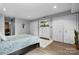 Bright bedroom featuring a bed with floral bedding, closet, mirrored storage and light wood floors at 5192 Corbin Ln, Hickory, NC 28601