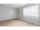 Sun-filled bedroom features natural light from window with sheer curtains and wood-look flooring at 5192 Corbin Ln, Hickory, NC 28601