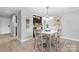 Well-lit dining area featuring a stylish table set, a view into the kitchen, and modern decor at 5192 Corbin Ln, Hickory, NC 28601
