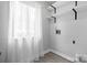Bright laundry room features natural light from window with white curtains and white storage shelves at 5192 Corbin Ln, Hickory, NC 28601