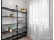 Bright spare room features natural light from window with sheer curtains and open storage shelves at 5192 Corbin Ln, Hickory, NC 28601