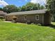 Landscaped backyard with mature trees and green lawn providing privacy at 5238 Bethel Church Rd, Hickory, NC 28602