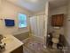 Well-lit bathroom with a tub/shower combo, neutral color scheme, and a single sink vanity at 5238 Bethel Church Rd, Hickory, NC 28602