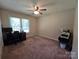 Carpeted bedroom with a ceiling fan and a window providing natural light at 5238 Bethel Church Rd, Hickory, NC 28602