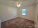 Carpeted bedroom with neutral walls, ceiling fan, and natural light from the window at 5238 Bethel Church Rd, Hickory, NC 28602