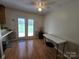 Bright dining area with hardwood floors, ceiling fan, and access to the backyard through glass doors at 5238 Bethel Church Rd, Hickory, NC 28602