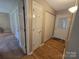 Hallway with hardwood floors leading to various rooms with multiple doors and closets at 5238 Bethel Church Rd, Hickory, NC 28602