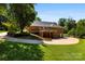 Spacious backyard featuring a beautiful brick home with an expansive deck and well-maintained lawn at 600 Queens Rd, Cherryville, NC 28021