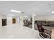 A view of the vast carpeted basement, showcasing the seating area and space for multiple activities at 600 Queens Rd, Cherryville, NC 28021