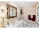 Cozy bathroom featuring an ornate mirror, floral wallpaper and white vanity at 600 Queens Rd, Cherryville, NC 28021