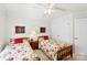 Bedroom features twin beds, neutral walls, ceiling fan, and simple decor at 600 Queens Rd, Cherryville, NC 28021