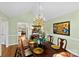 A formal dining room with a chandelier, hardwood floors, and elegant decor, perfect for entertaining guests at 600 Queens Rd, Cherryville, NC 28021