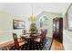 Elegant dining room with hardwood floors, chandelier, and large window for natural light at 600 Queens Rd, Cherryville, NC 28021