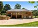 Exterior of a two-story red brick home with an elevated deck, a basement level garage, and a spacious yard at 600 Queens Rd, Cherryville, NC 28021