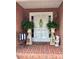 Inviting front porch decorated with potted ferns, a wreath, and a charming bench at 600 Queens Rd, Cherryville, NC 28021