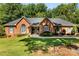 Charming one-story brick home featuring lush landscaping and a well-manicured lawn, perfect for curb appeal at 600 Queens Rd, Cherryville, NC 28021