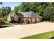Spacious three-car garage with an expansive driveway and manicured lawn, creating a welcoming approach at 600 Queens Rd, Cherryville, NC 28021