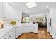 Bright kitchen features white cabinetry, hardwood floors, and an open layout to the dining area at 600 Queens Rd, Cherryville, NC 28021