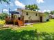 View of the backyard, deck, and exterior of the house with green grass and landscaping at 618 Springfield Nw Dr, Concord, NC 28027