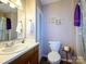 Bathroom with a vanity, toilet, and framed pictures on the wall at 618 Springfield Nw Dr, Concord, NC 28027