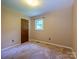 Cozy bedroom with neutral carpet, natural light from the window, and a spacious closet at 618 Springfield Nw Dr, Concord, NC 28027