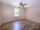 Bright room with laminate floors and a neutral paint at 618 Springfield Nw Dr, Concord, NC 28027