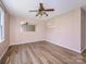 Spacious bedroom with a ceiling fan and stylish laminate flooring at 618 Springfield Nw Dr, Concord, NC 28027