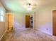 Bedroom features neutral carpet, a ceiling fan, and access to an adjacent bathroom with a laundry at 618 Springfield Nw Dr, Concord, NC 28027