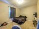 Neutral bedroom featuring tan walls, carpet, and dark brown bedding and curtains at 618 Springfield Nw Dr, Concord, NC 28027