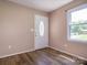 Bright entryway with wood-look flooring, a glass-accented door, and a window offering natural light into the home at 618 Springfield Nw Dr, Concord, NC 28027