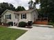 Well-maintained home featuring a lovely deck, manicured lawn, and convenient paved driveway at 618 Springfield Nw Dr, Concord, NC 28027
