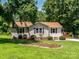 Charming single-story home with a well-manicured lawn and mature trees in a suburban setting at 618 Springfield Nw Dr, Concord, NC 28027
