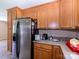 Spacious kitchen with stainless steel refrigerator, wood cabinets, and plenty of countertop space at 618 Springfield Nw Dr, Concord, NC 28027