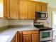 Charming kitchen featuring stainless steel appliances, wood cabinets, and ample counter space at 618 Springfield Nw Dr, Concord, NC 28027