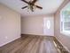 Open concept living room with a ceiling fan, laminate floors, and natural light at 618 Springfield Nw Dr, Concord, NC 28027