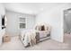 Comfortable bedroom with a mounted TV, cozy bed, natural light, and stylish furnishings with neutral decor at 6365 Ashton Park Dr, Denver, NC 28037