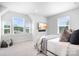 Serene bedroom featuring a TV, cozy bed, ample natural light from the large windows, and neutral decor at 6365 Ashton Park Dr, Denver, NC 28037