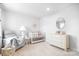 This bedroom features a crib, dresser, rocking chair and neutral decor at 6365 Ashton Park Dr, Denver, NC 28037