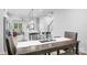 Open-concept dining area flowing into a living room with a kitchen island and a staircase in view at 6365 Ashton Park Dr, Denver, NC 28037