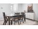 Bright dining area with a rustic wood table, stylish seating, and a decorative cabinet at 6365 Ashton Park Dr, Denver, NC 28037