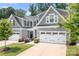 Charming gray home with a two-car garage, green lawn, and inviting front entrance at 6365 Ashton Park Dr, Denver, NC 28037