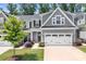 Charming gray two-story home with a well-manicured lawn, two-car garage, and inviting landscaping at 6365 Ashton Park Dr, Denver, NC 28037