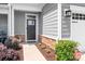 Inviting front entrance featuring a dark-colored door, stone accents, and well-maintained landscaping at 6365 Ashton Park Dr, Denver, NC 28037